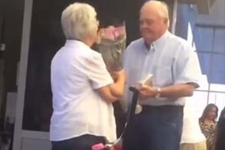 こんな夫婦になりたいな。花束を持って心待ちにするおじいさんが愛の抱擁