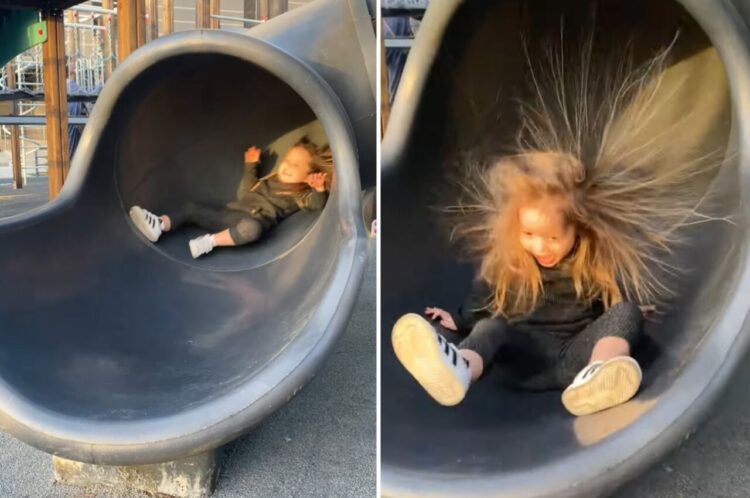 楽しげな声をあげながらトンネル型のすべり台からおりてきた女の子。その髪の毛が静電気でスゴいことに！！【海外・動画】